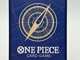 a close up of a one piece card game on a stand