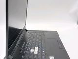 a black laptop computer sitting on a white surface