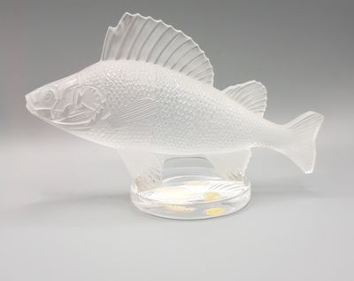 a glass fish that is sitting on a table