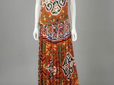 an orange and black patterned dress with a halt neck