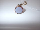 a white necklace with a blue glass pendant on it