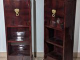 two wooden cabinets with brass handles on each of them