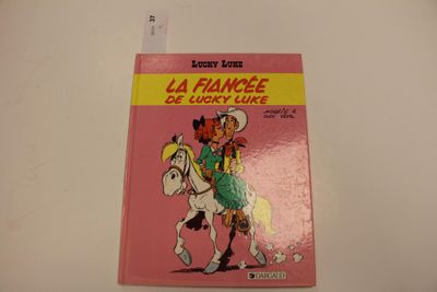 un livre rose avec l'image d'un cow-boy à cheval