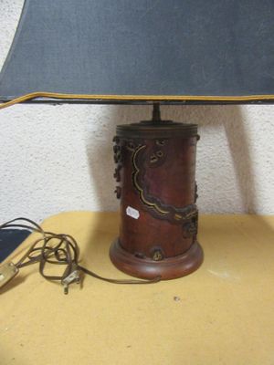a lamp that is sitting on a table with a lamp shade on it