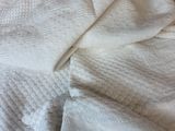 an image of a bed with a white blanket and a pillow