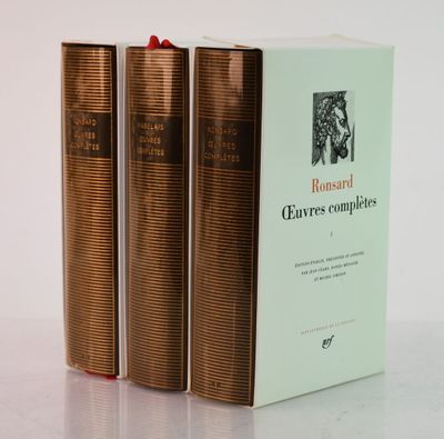three books sitting on top of a white table next to each other