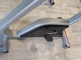 an overhead view of a stationary exercise bike on a wooden floor