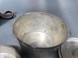 a pair of scissors sitting next to a metal bowl