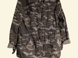 an image of a camouflage jacket hanging on a clothes hanger