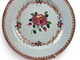 a white plate with a rose design on it