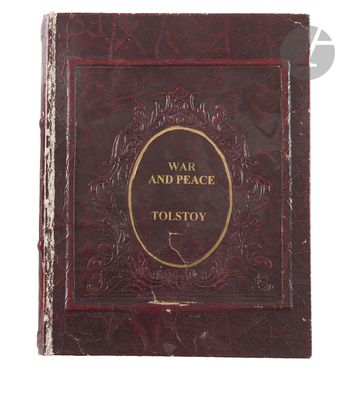 the front cover of a red book with gold lettering on it