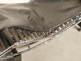 a black and white photo of a chaise lounger