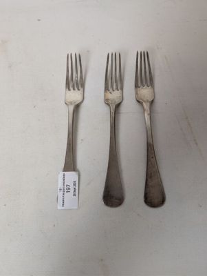 three forks and a knife on a table with a price tag