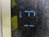 a digital clock on the side of a microwave