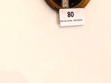 many portraits of people on the wall of this room