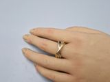 a woman ' s hand with a gold ring on it