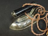 an old iron and a rope on a black surface