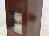 a small wooden box with a glass door on it