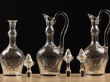 three clear glass vases sitting on top of a wooden table