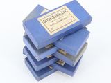 several blue books stacked on top of each other on a white surface