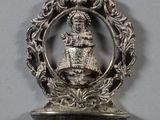 a small silver object hanging from the wall