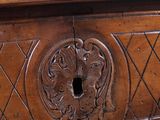 a wooden table with a carved design on the top of it