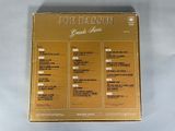 a gold box with a list of various songs on it