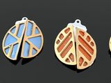 four pendants of different shapes and colors on a black surface