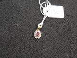 a close up of a necklace on a black surface with a price tag