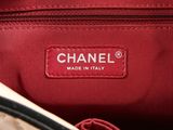a close up of a chanel bag with a tag on it