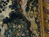 a tapestry hanging on the wall of a room with a painting on it