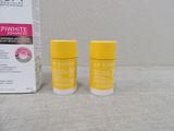 two bottles of lip bale sitting next to a box of lip bales