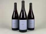 three bottles of wine sitting next to each other on a table