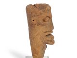 statue of a man ' s face on a base with a white background