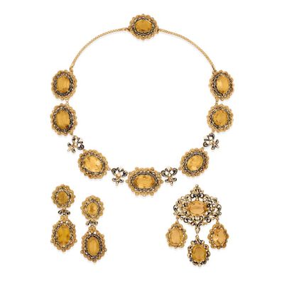 an image of a necklace and earring set with yellow stones