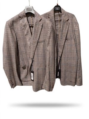 two jackets hanging on a hanger on a white background