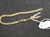 a gold chain with a tag attached to it