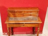 a small desk with a drawer on top of it