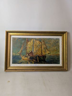 une photo d'un tableau représentant un voilier, dans un cadre doré