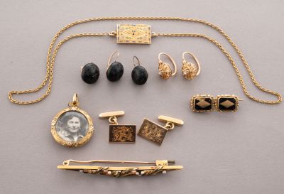 an assortment of jewelry including a necklace, earrings, and a broochle