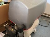 a machine that is sitting on the floor in front of boxes