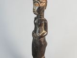 a close up of a wooden statue on a white background
