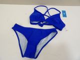 a blue bikini top and panties on a white table