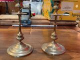 two candles sitting on a wooden table in a store