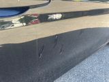 a close up of a car ' s door handle with a reflection on it