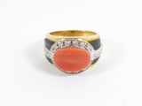 an image of a ring with a coral stone surrounded by diamonds