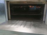 an oven with a door open on a kitchen counter
