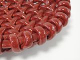 a close up of a red glass bead
