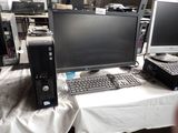 a desk with a computer and a keyboard on it