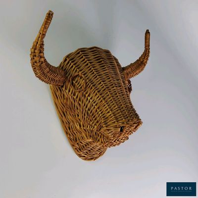 a wicker bull head mounted on the wall